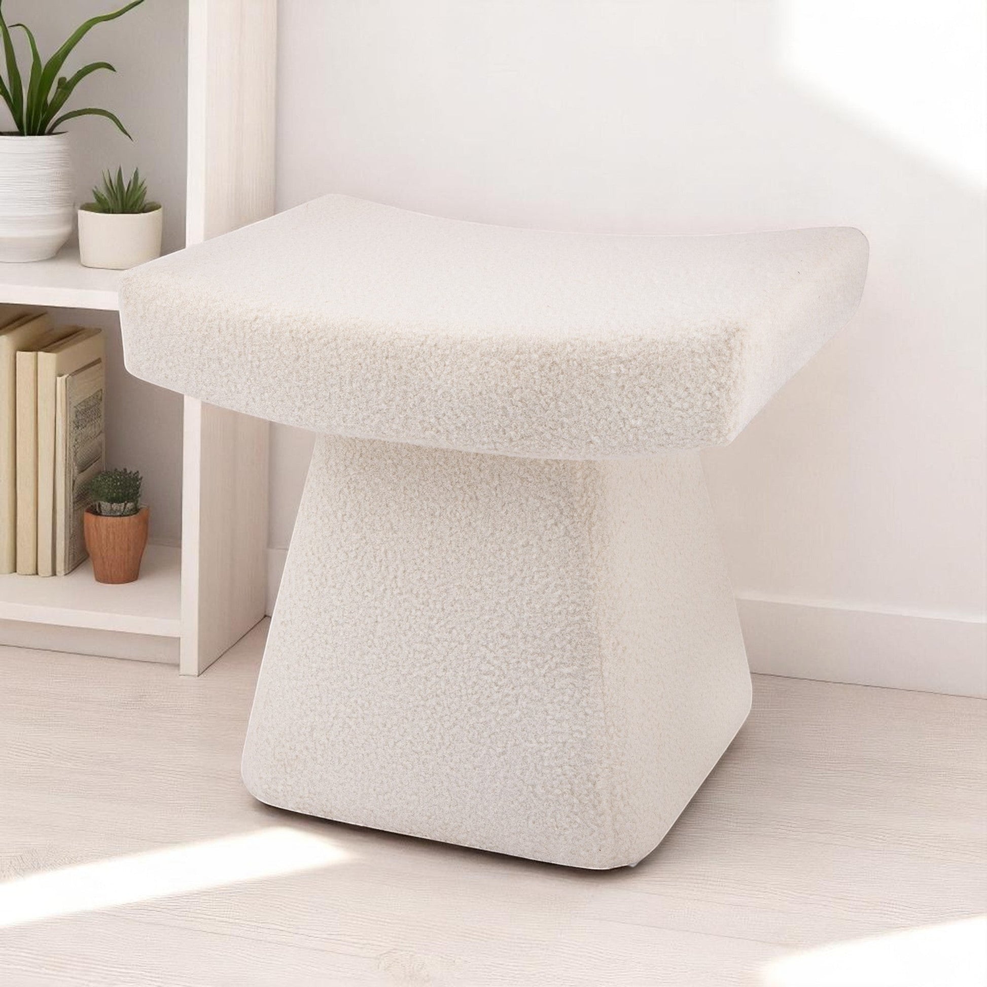 Casa Verve Furniture cream bouclé ottoman with a sculptural, architectural design. Perfect as a footrest or accent seat.