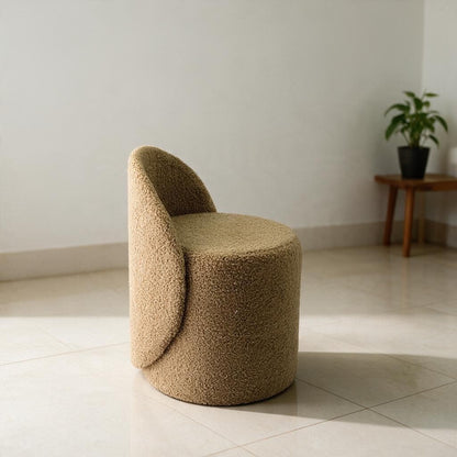 Prisma bouclé accent chair in camel styled in a sunlit Indian bedroom