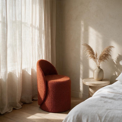 Prisma bouclé accent chair in terracotta styled in a sunlit Indian bedroom