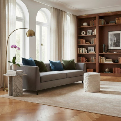 Casa Verve Furniture cream textured round ottoman with raised bohemian patterns, used as a footrest.