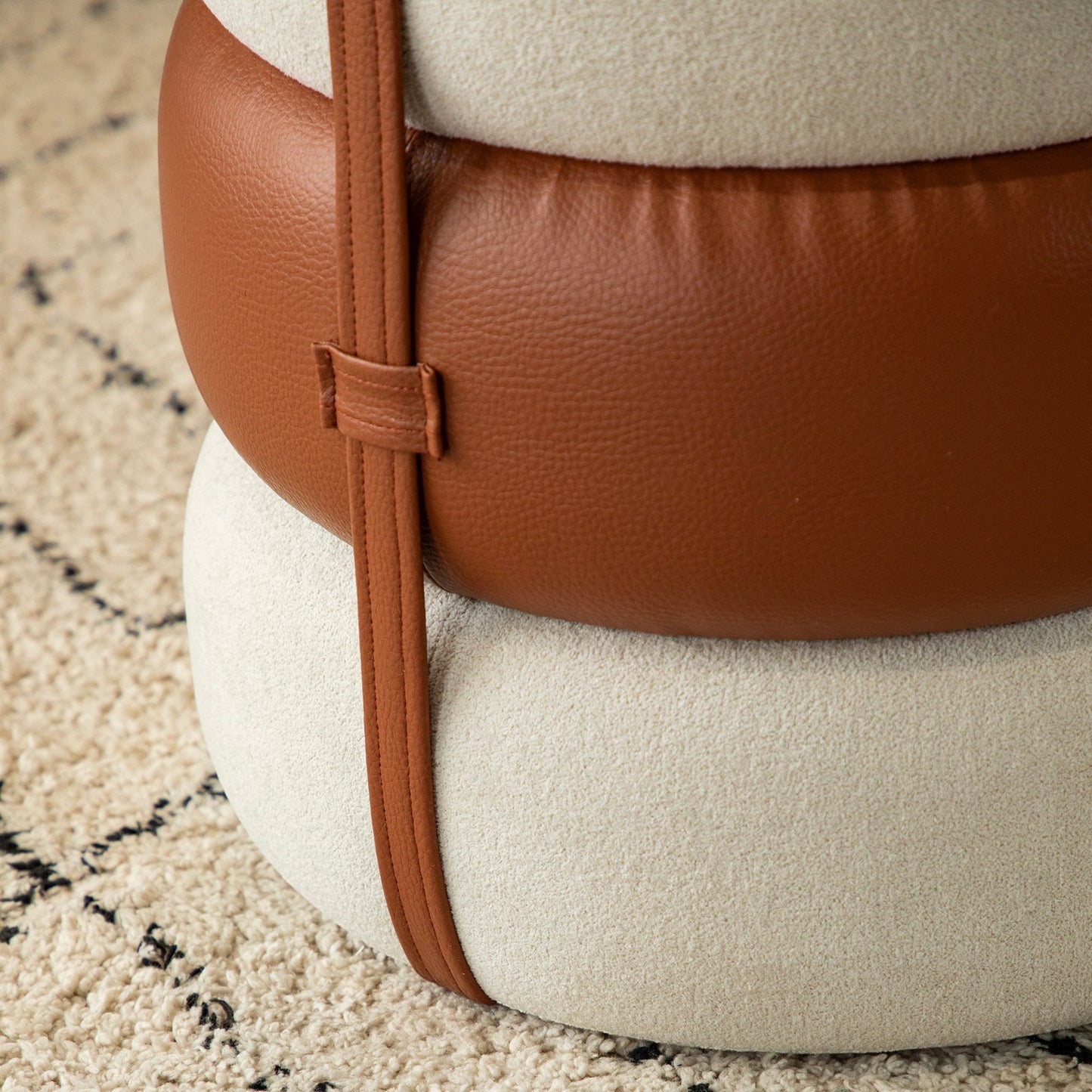 Casa Verve Furniture Terraroza Ottoman: stacked cushion design in cream boucle fabric with brown PU leather accents and straps.